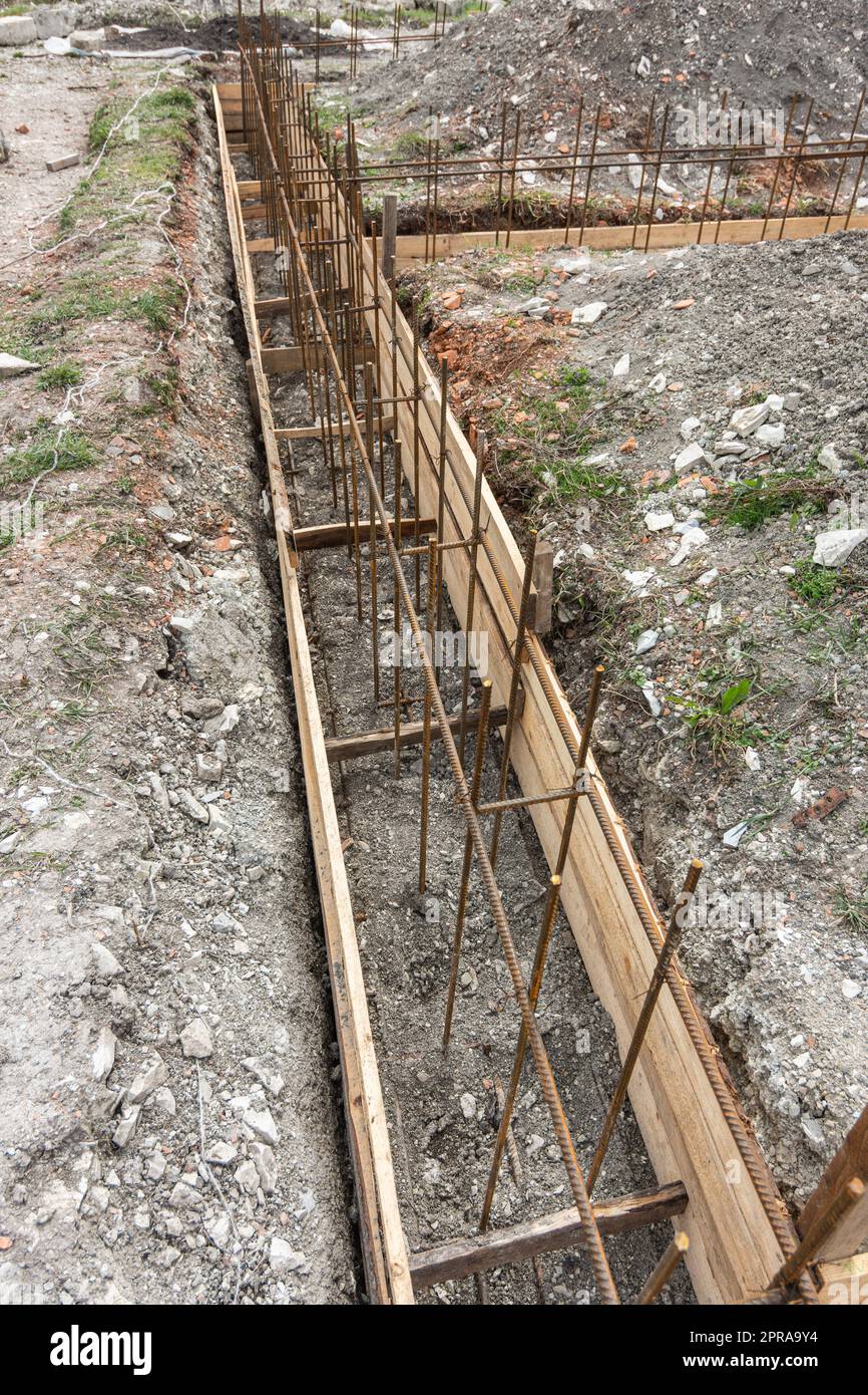 Fragment of reinforcement of a shallowly buried strip foundation of a low-rise residential building Stock Photo