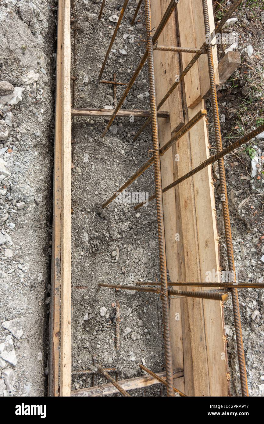 Partially buried bonded reinforcement and strip foundation formwork Stock Photo