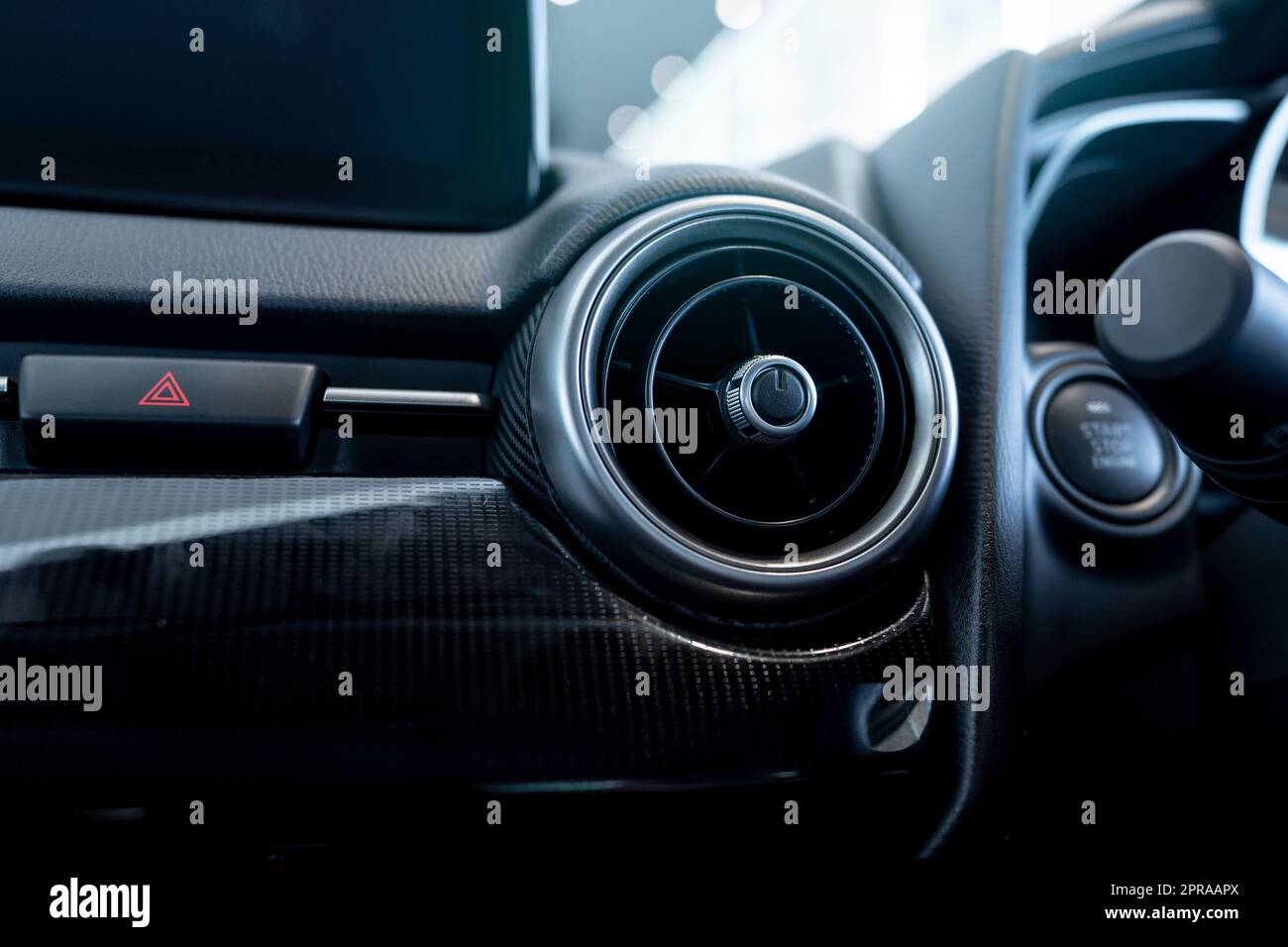 Car air vent. Car air conditioner. Automobile air conditioning system. Car ventilation system. Auto interior. Ventilation system in vehicle. Round air vent with modern design and adjusting knob. Stock Photo