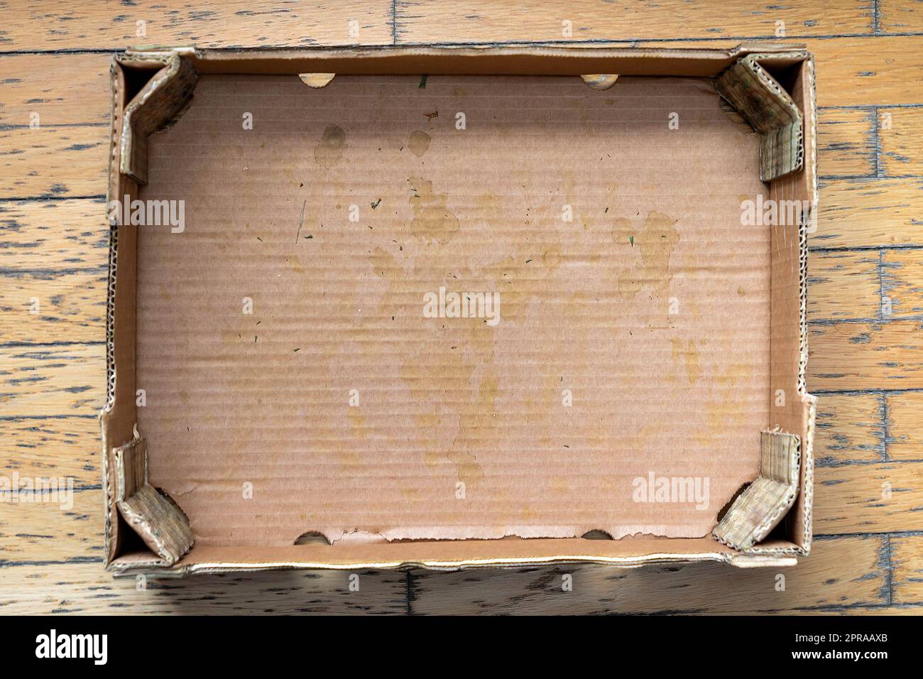 Empty dirty used cardboard box on wooden floor Stock Photo Alamy