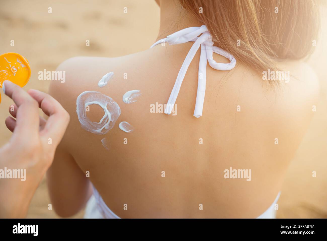 young man applying suntan lotion with sun shape on girlfriend back shoulder Stock Photo Alamy