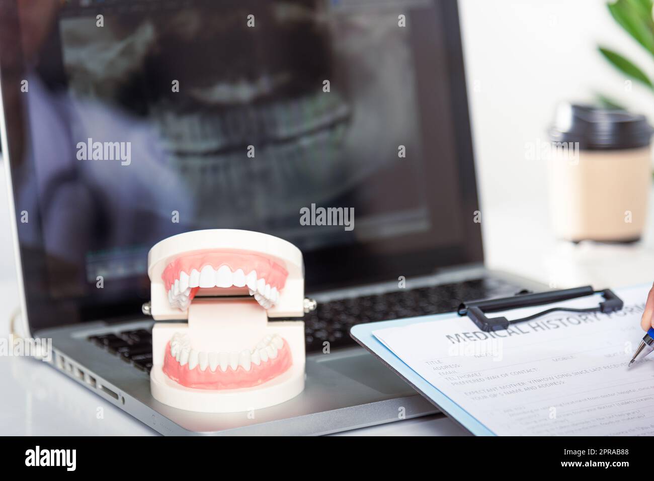 Dentist doctor in uniform writing information of patient in paperwork