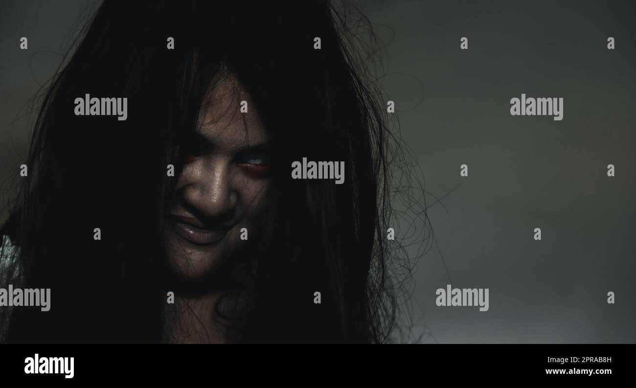 Portrait of Asian ghost or zombie horror creepy scary have hair covering the face Stock Photo