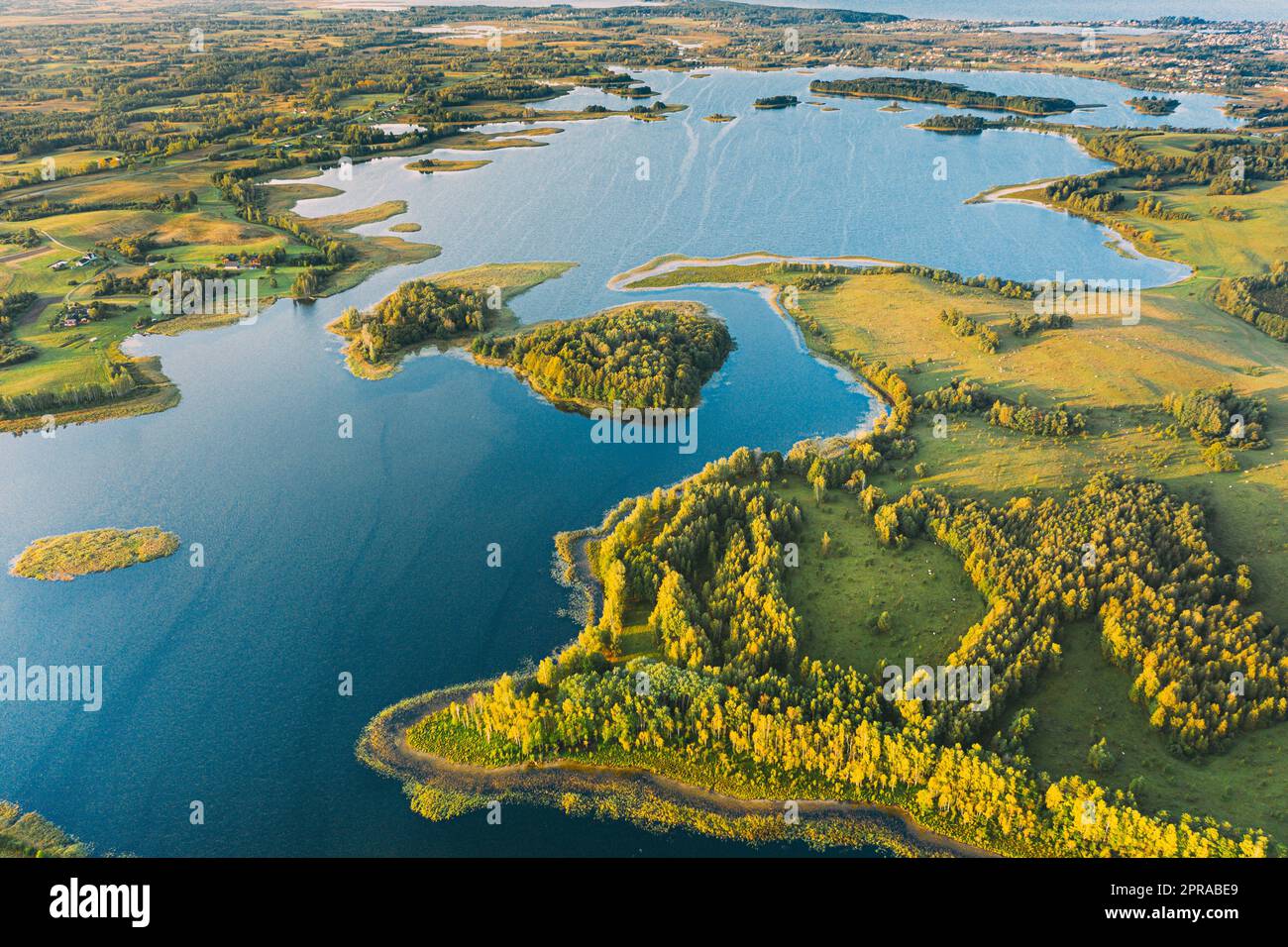 Braslaw Or Braslau, Vitebsk Voblast, Belarus. Aerial View Of Nedrava Lake And Green Forest Landscape In Sunny Autumn Morning. Top View Of Beautiful European Nature From High Attitude. Bird's Eye View. Famous Lakes. Natural Landmarks Stock Photo