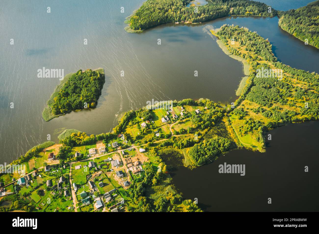 Lyepyel District, Lepel Lake, Beloozerny District, Vitebsk Region. Aerial View Of Residential Area With Houses In Countryside. Top View Of Island Pension Lode From High Attitude In Autumn Sunny Day. Bird's Eye View. Flat View Stock Photo