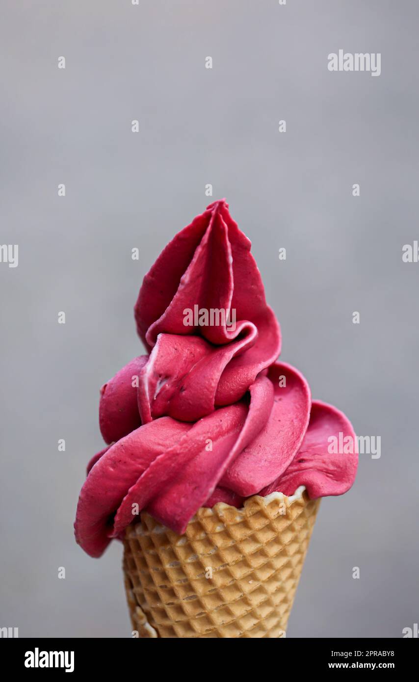 A waffle ice cream cone filled with a delicious freshly made raspberry