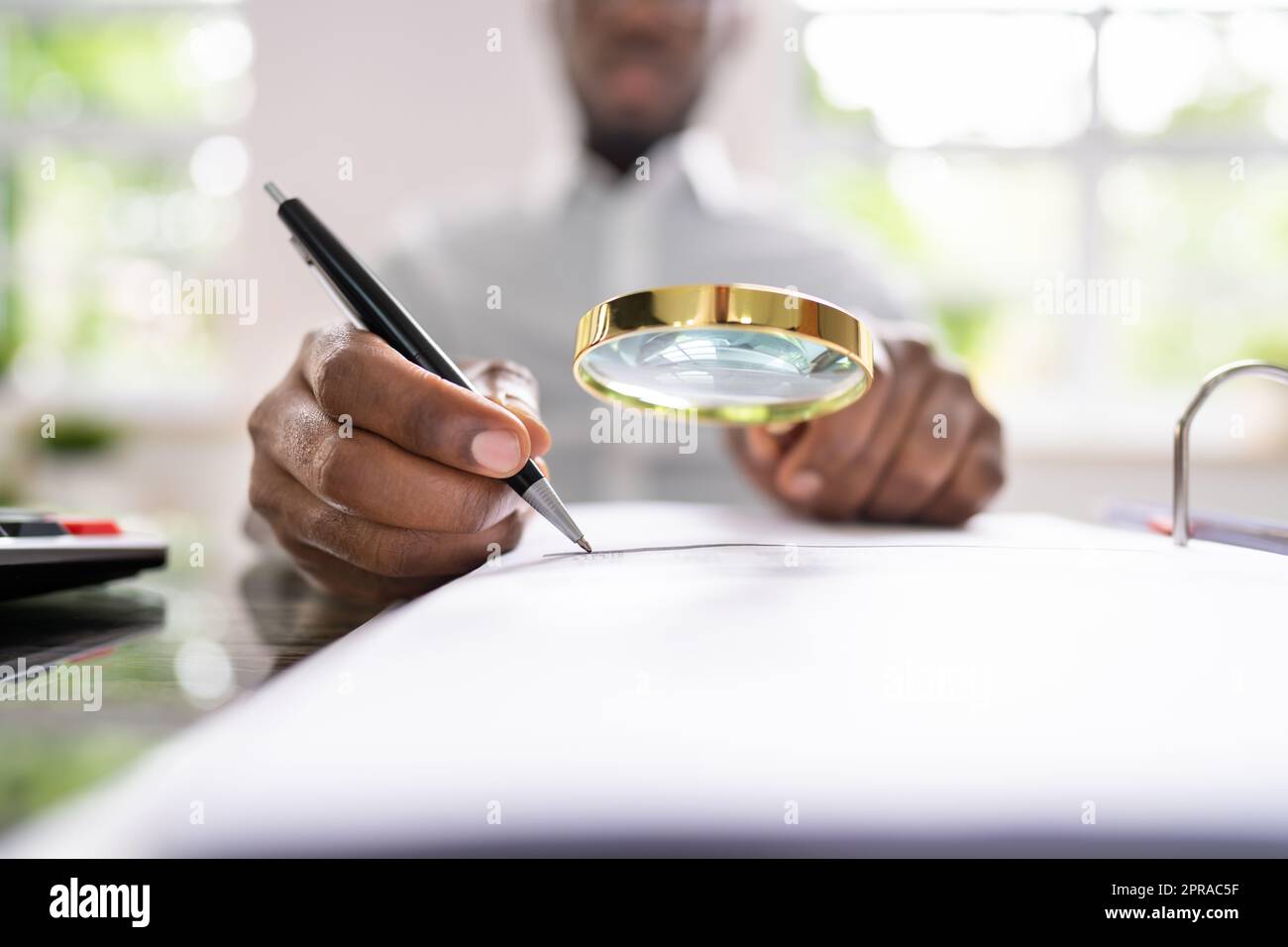 Corporate Auditor Using Magnifying Glass Stock Photo - Alamy
