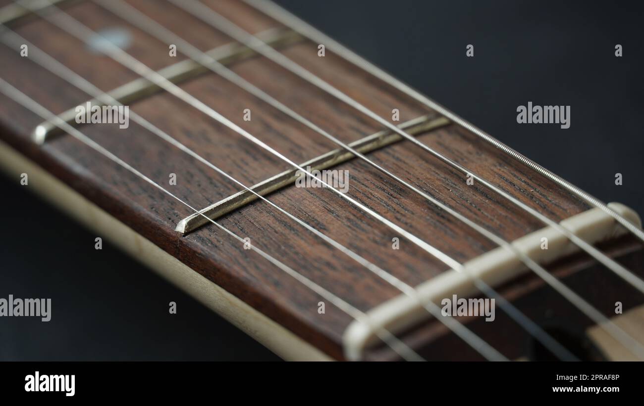 Guitar neck of black electric guitar on dark background Stock Photo