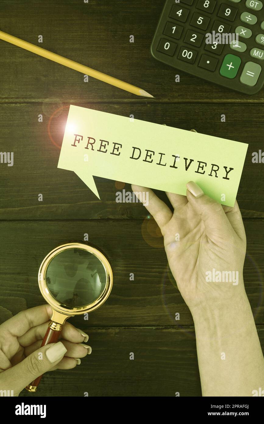 Handwriting text Free Delivery. Business idea Shipping Package Cargo Courier Distribution Center Fragile Hands Of Woman With Thought Bubble Paper And Stationery Over Wood. Stock Photo