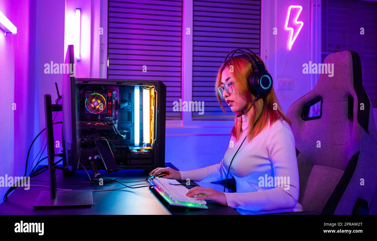 Happy Asia Girl Gamer Wear Headphone Competition Play Video Game Online  With Smartphone Colorful Neon Lights In Living Room At Home Stock Photo -  Download Image Now - iStock