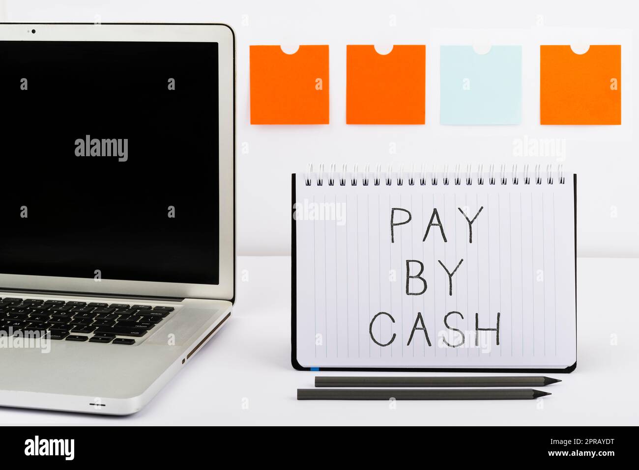 Conceptual caption Pay By Cash. Internet Concept Customer paying with money coins bills Retail shopping Important Messages On Notebook And Lap Top On Desk With Office Supplies. Stock Photo