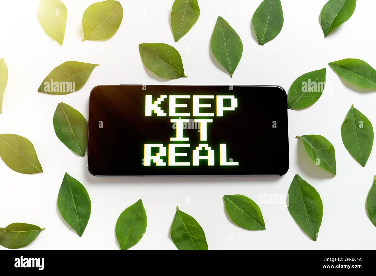 Sign displaying Keep It Real. Business overview Be yourself honest authentic genuine tell the truth always Smartphone Surrounded And Leaves Presenting Creative Promotion Ideas. Stock Photo