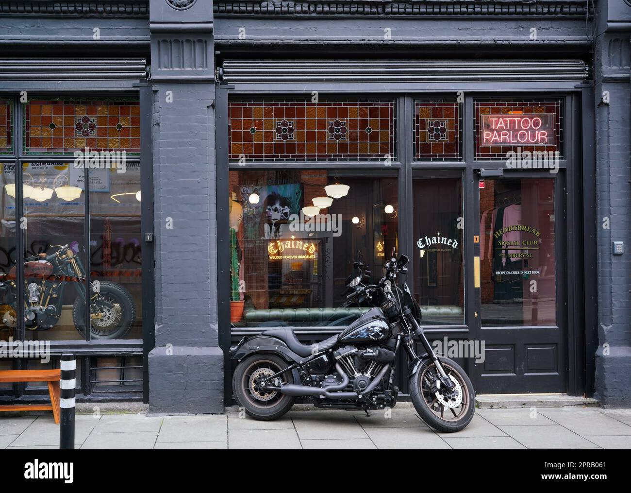 Motorcycle in front of ornate old store Stock Photo Alamy