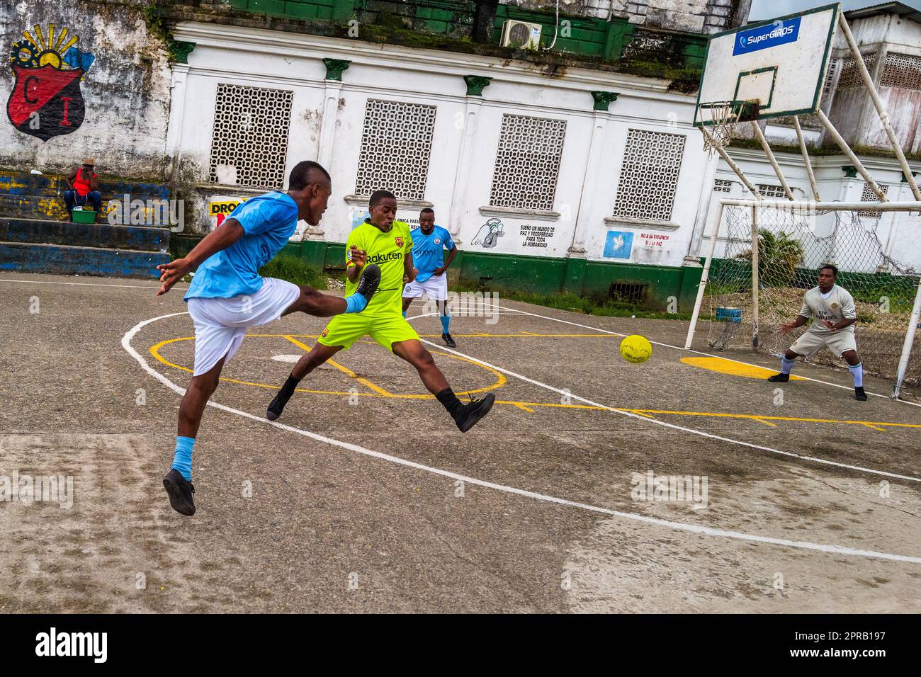 Young Afro-Colombian football players play a friendly match on a concrete playing field in Quibdó, Chocó, Colombia. Stock Photo