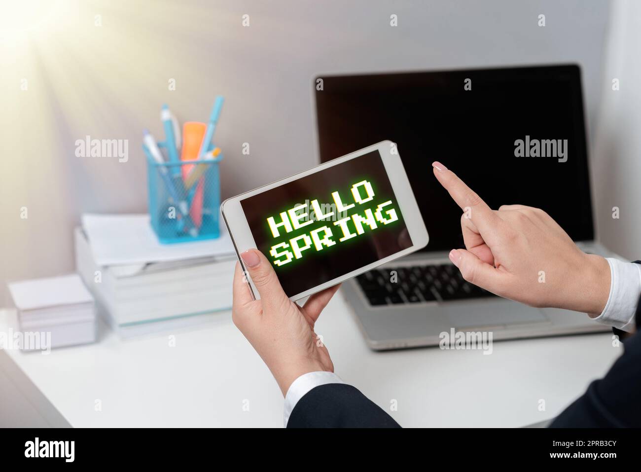 Inspiration showing sign Hello Spring. Word Written on Welcoming the season after the winter Blossoming of flowers Businesswoman Holding Tablet And Pointing With One Finger On Important News Stock Photo
