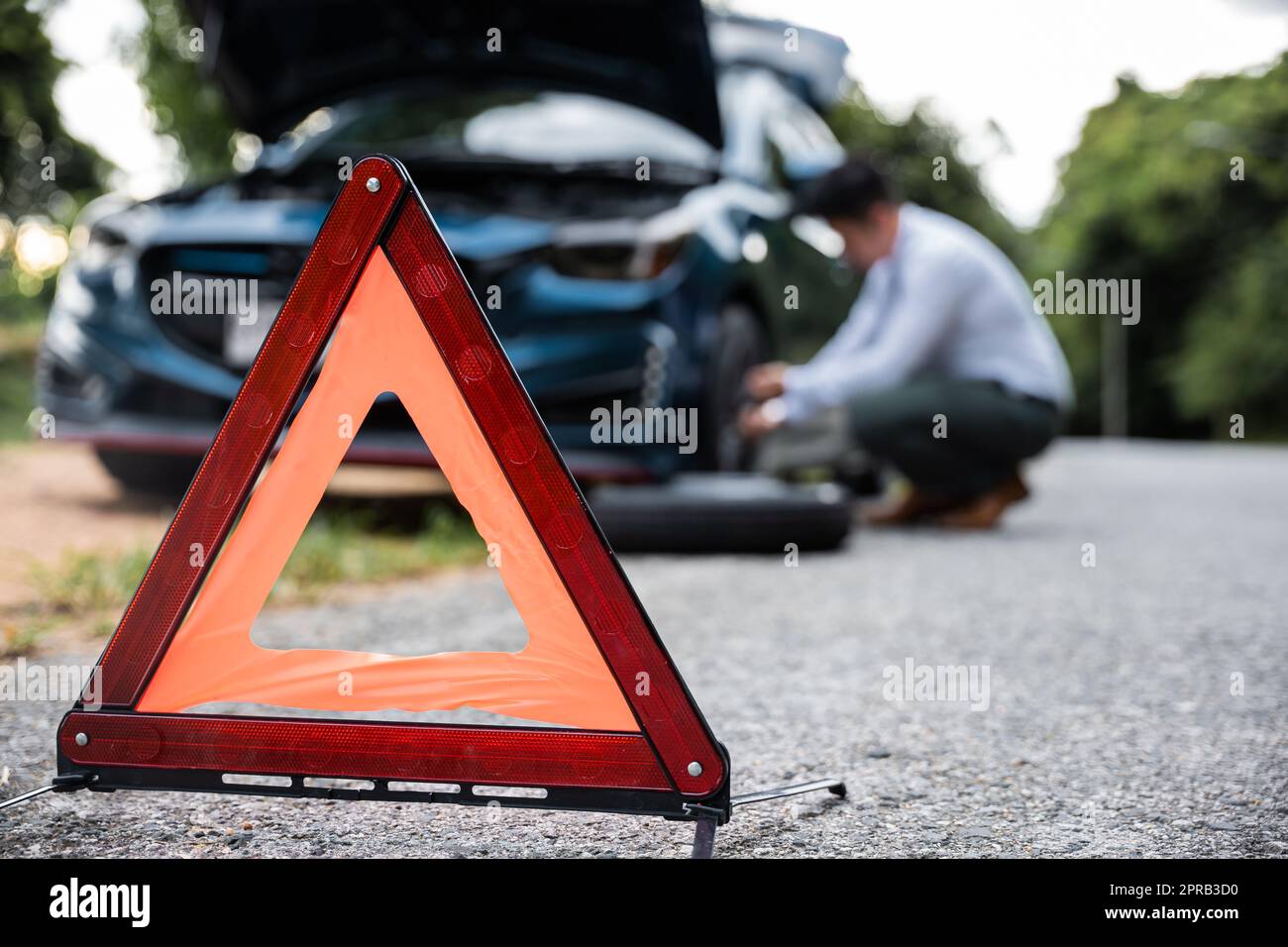 Asian businessman car broken has problems with wheel of his car Stock Photo