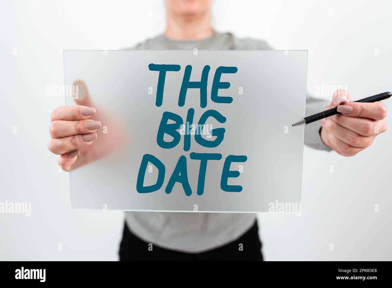 Writing displaying text The Big Date. Business idea Important day for a couple relationship wedding anniversary Woman Holding Pen And Placard Advertising Business For Growth. Stock Photo