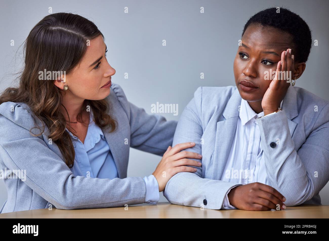 Resilience is accepting your new reality. a young woman comforting her colleague at work. Stock Photo