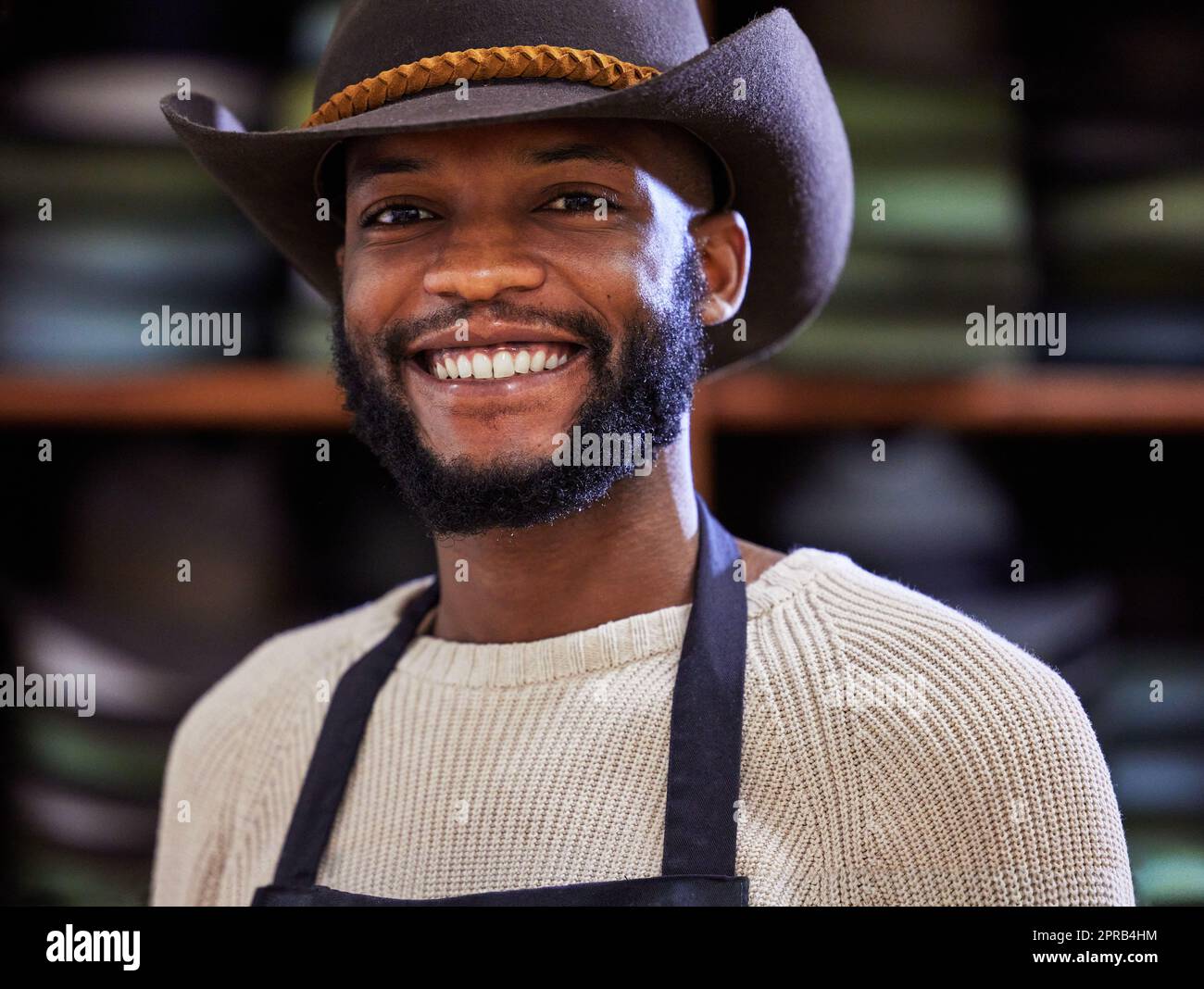 Only the hardworking survive. a young man working at his job in a shop. Stock Photo