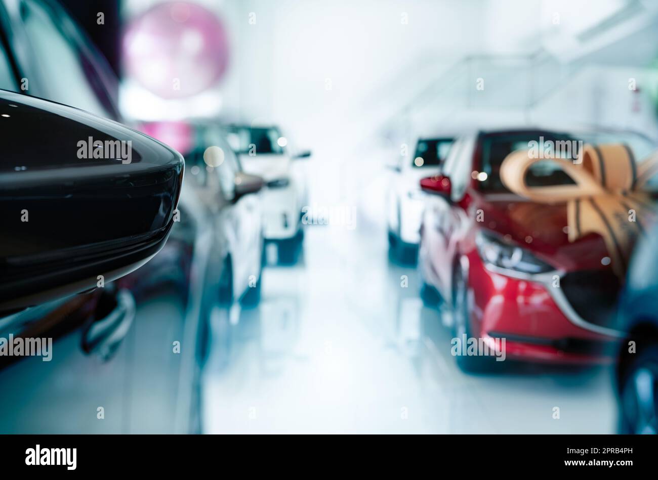 Car parked in luxury showroom. New car parked in modern showroom. Car dealership office. Automobile leasing and insurance concept. Automotive industry. Auto leasing business. Electric vehicle dealer. Stock Photo
