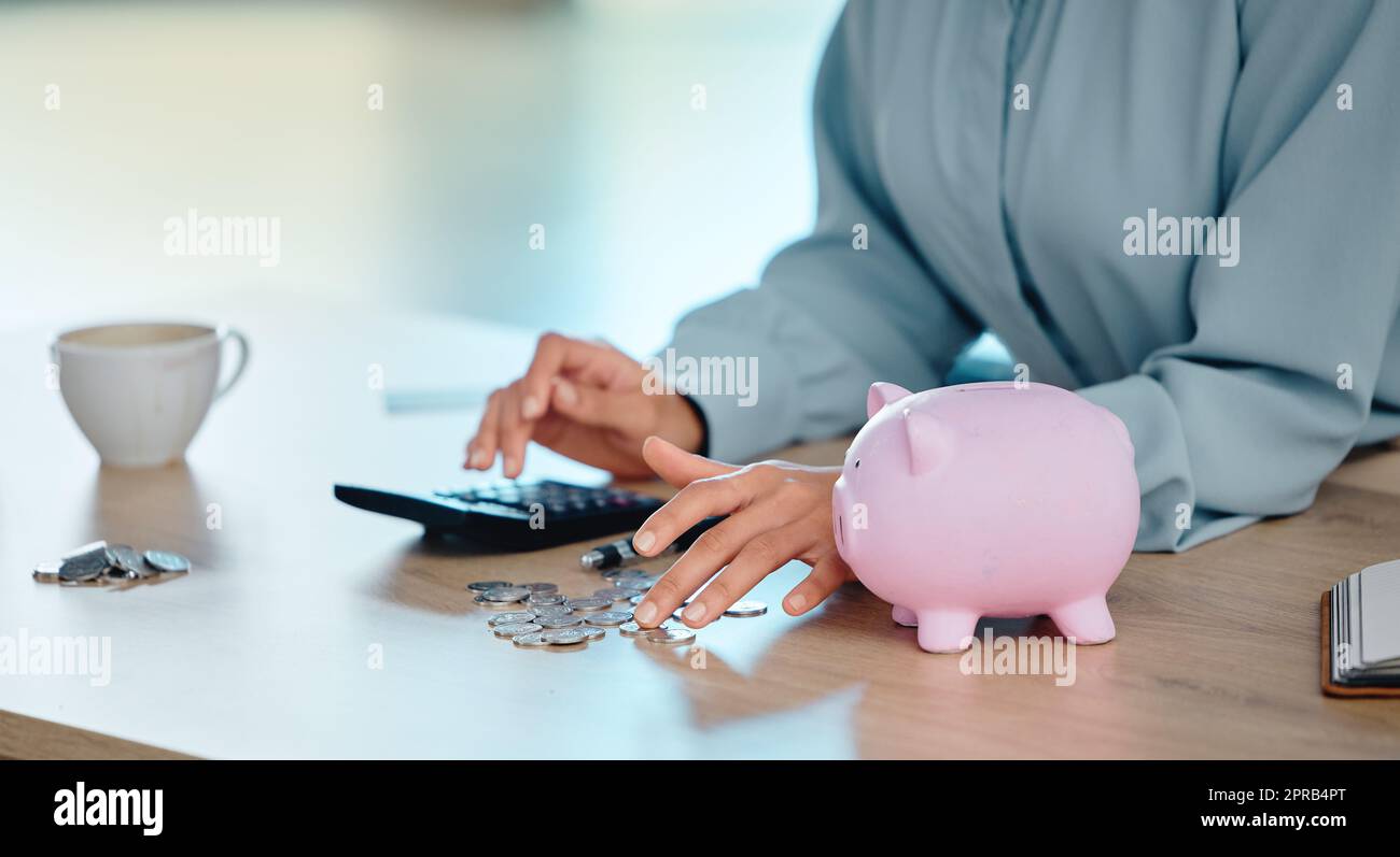 Finance, budget and saving money to deposit coins in a piggybank after calculating office budget. Financial manager hands counting cents or pennies, planning business spending and preparing for tax Stock Photo
