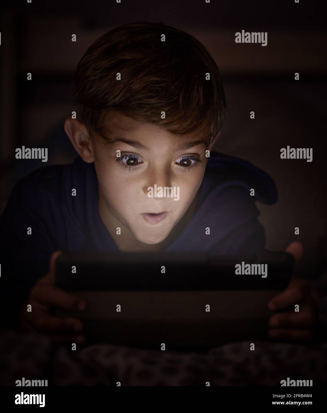 Die too young when wolfie comes, fee-fi-fo-fum. adorable little boy using a digital tablet at night. Stock Photo