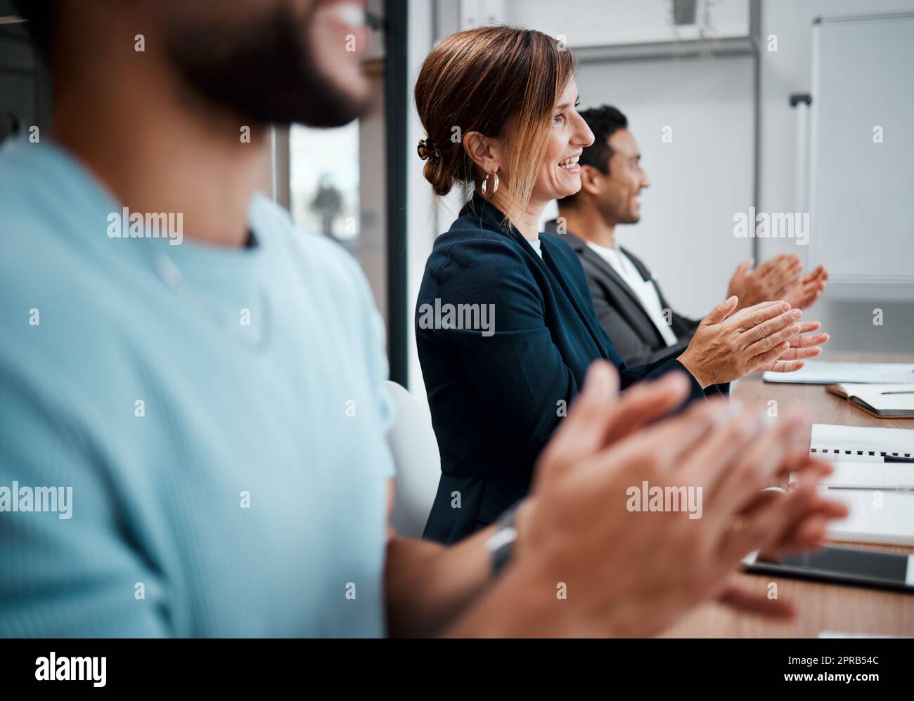 Weve finally reached our goals. a group of coworkers clapping during a business meeting. Stock Photo