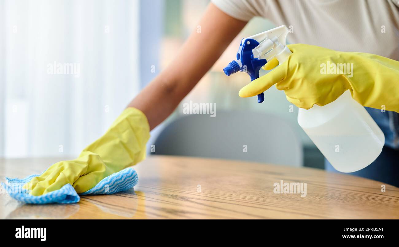 Dust wont win in this house. an unrecognizable person wiping a surface at home. Stock Photo