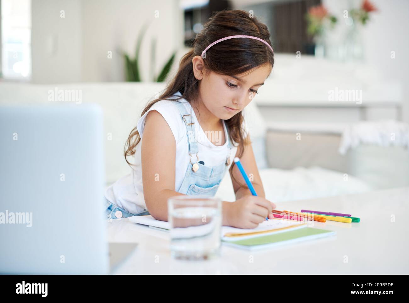 Girl writing in notebook in class hi-res stock photography and images ...