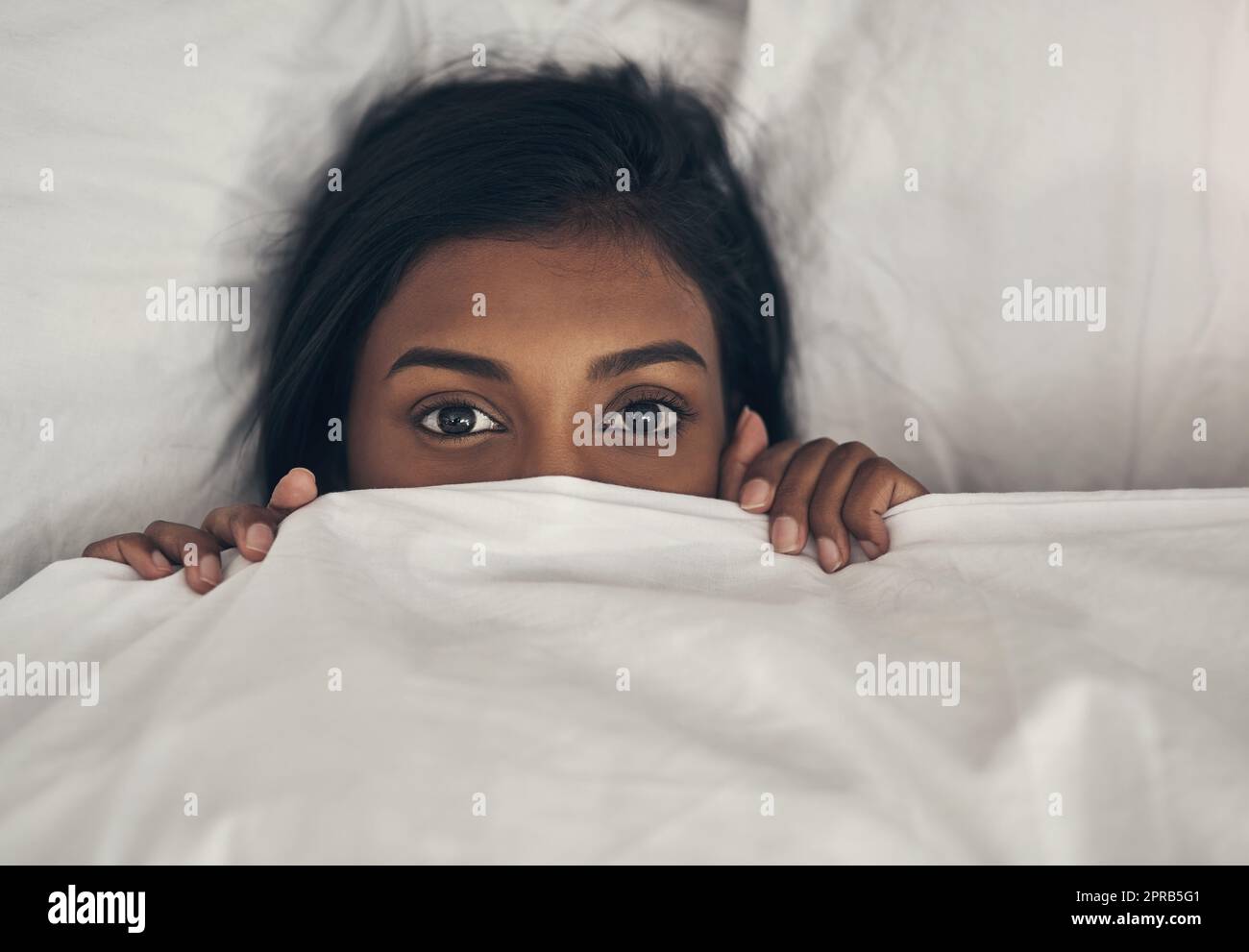 Its too cold to leave bed today. Portrait of a playful young woman