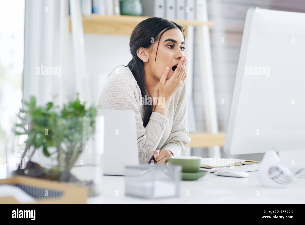 I totally forgot to finish this up. a young businesswoman looking shocked while using a computer in an office. Stock Photo