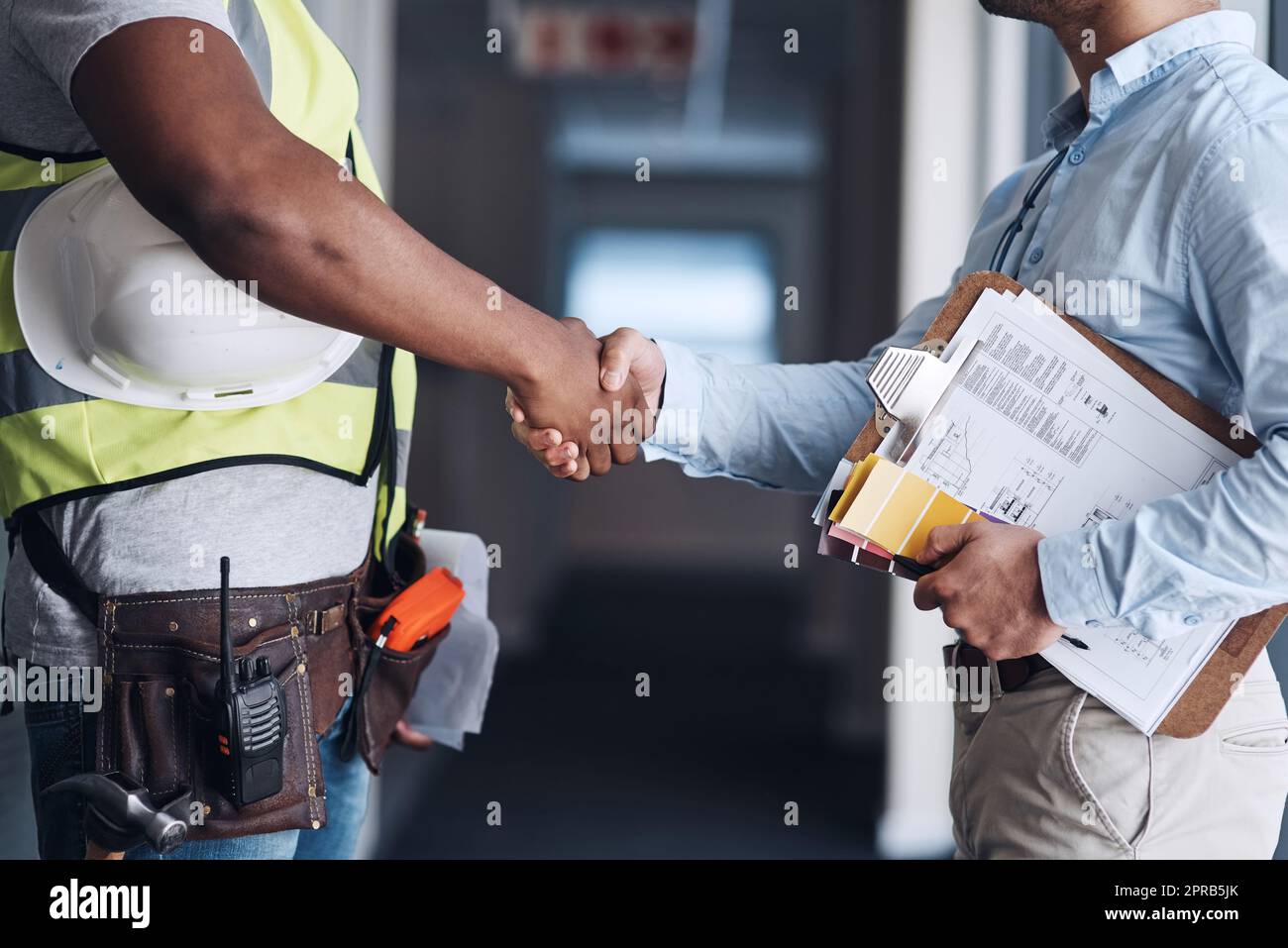 Well start the renovations then. two unrecognizable architects standing together and shaking hands after a discussion about the room before they renovate. Stock Photo