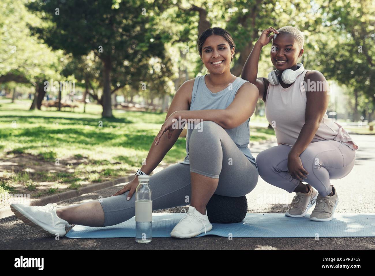 Working out with my best friend. two friends taking a break during their workout. Stock Photo