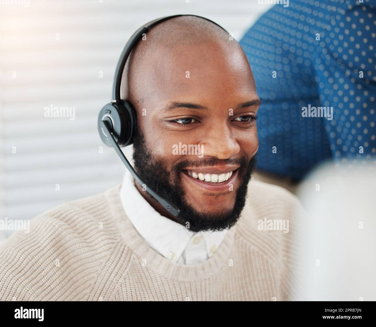 Solving each query with a smile. a handsome young salesman sitting in