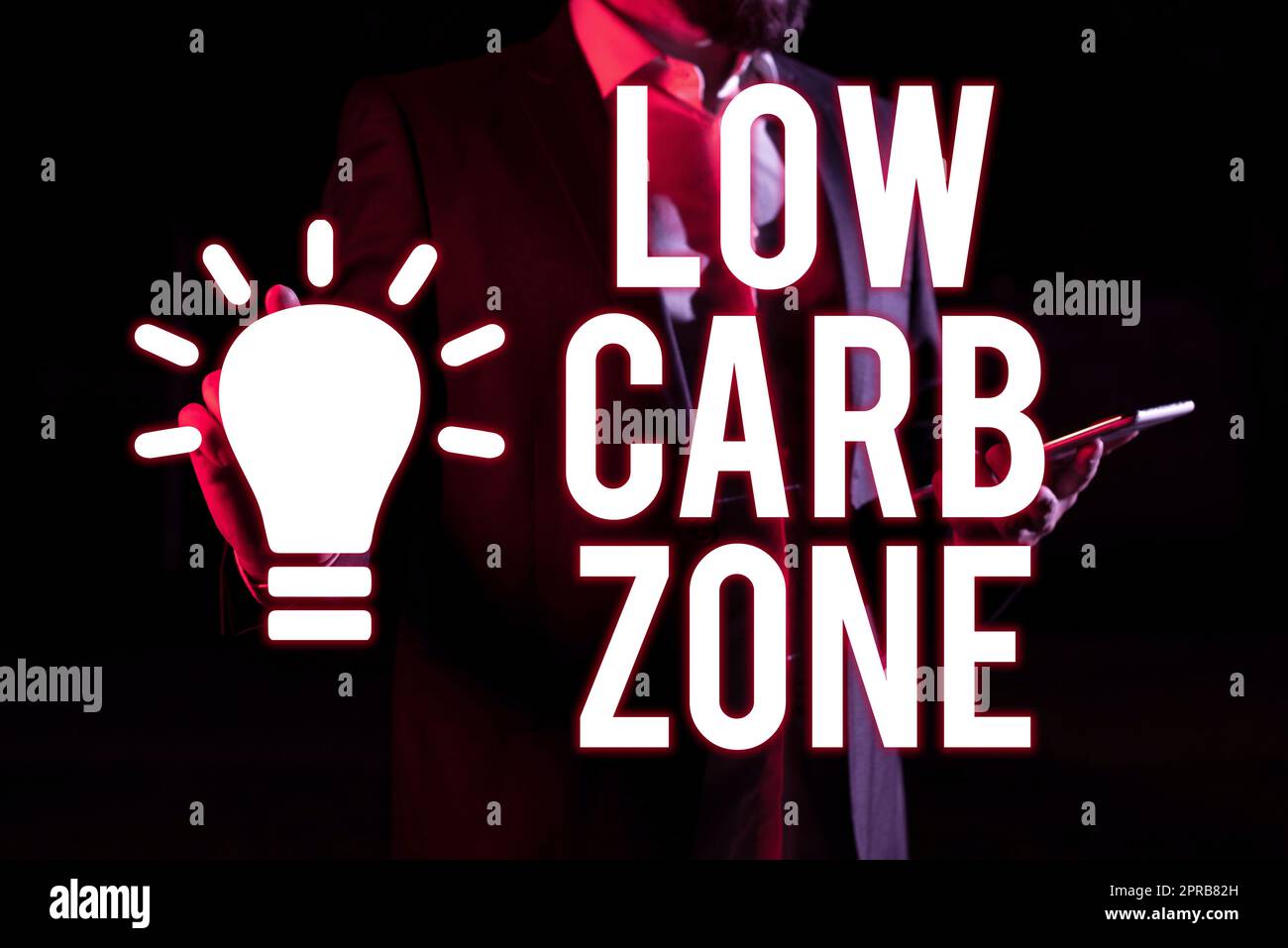 Conceptual caption Low Carb Zone. Word for Healthy diet for losing weight eating more proteins sugar free Man Holding Tablet And Pointing With One Finger On Important Message Stock Photo
