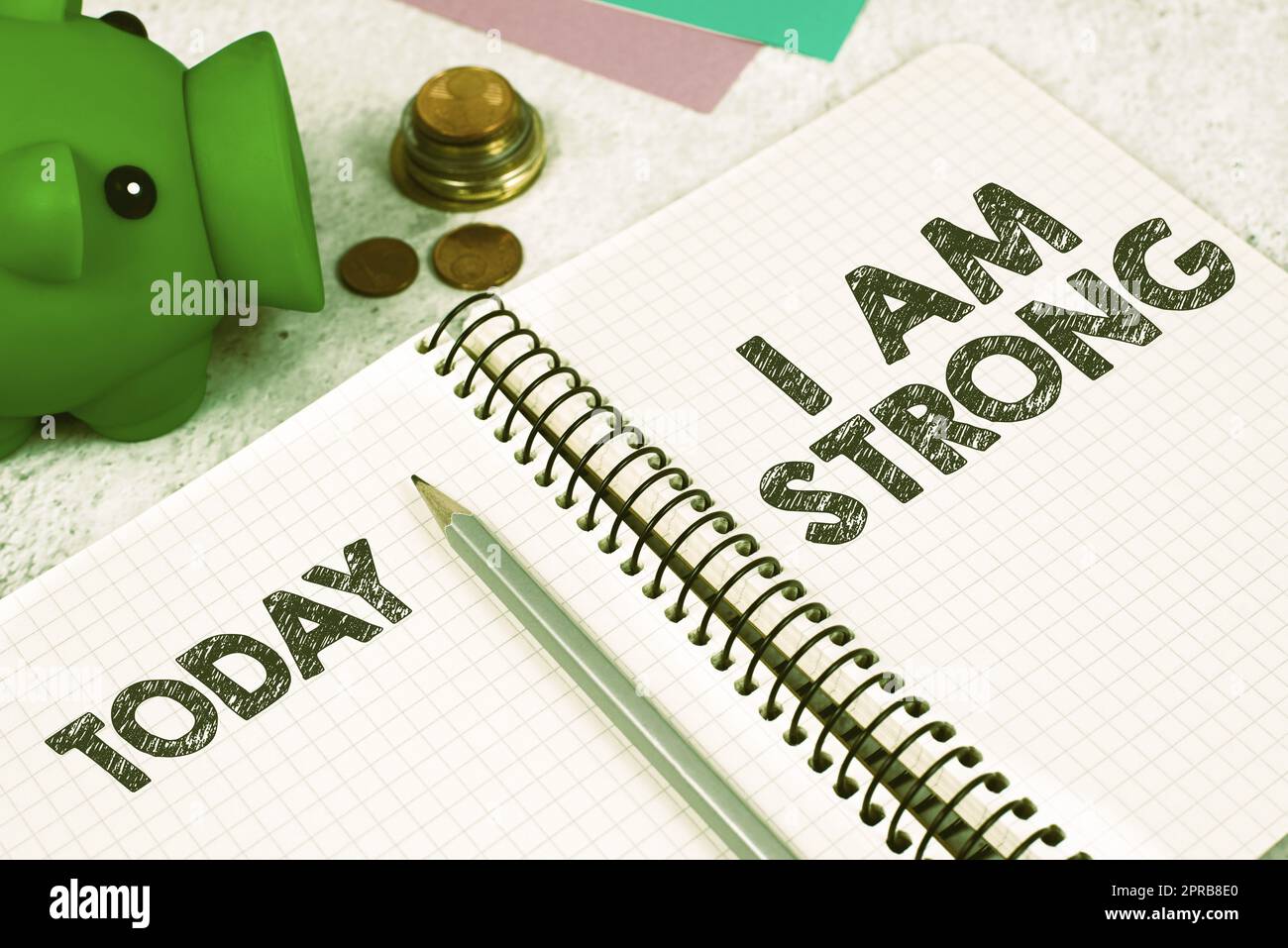 Conceptual display I Am Strong. Internet Concept Have great strength being healthy powerful achieving everything Important Message On Notebook On Desk With Money, Pen, Notes And Pig Box. Stock Photo