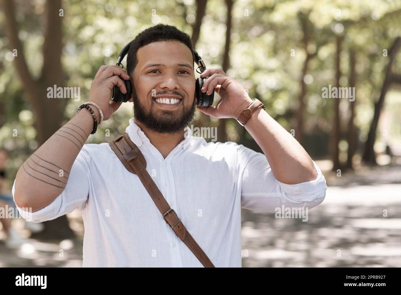 Music helps me prepare for the day. Portrait of a young businessman wearing headphones outdoors. Stock Photo