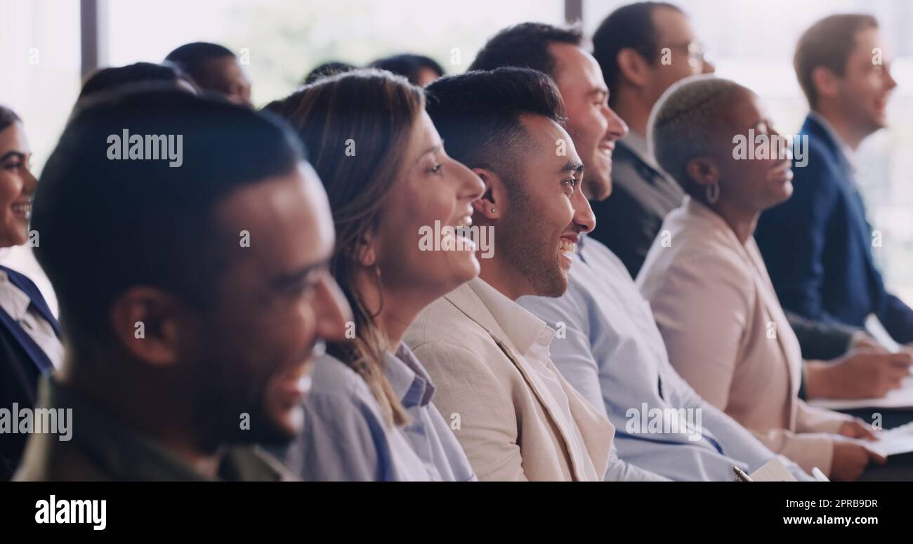 This talk is so informative and uplifting. a group of businesspeople attending a conference. Stock Photo