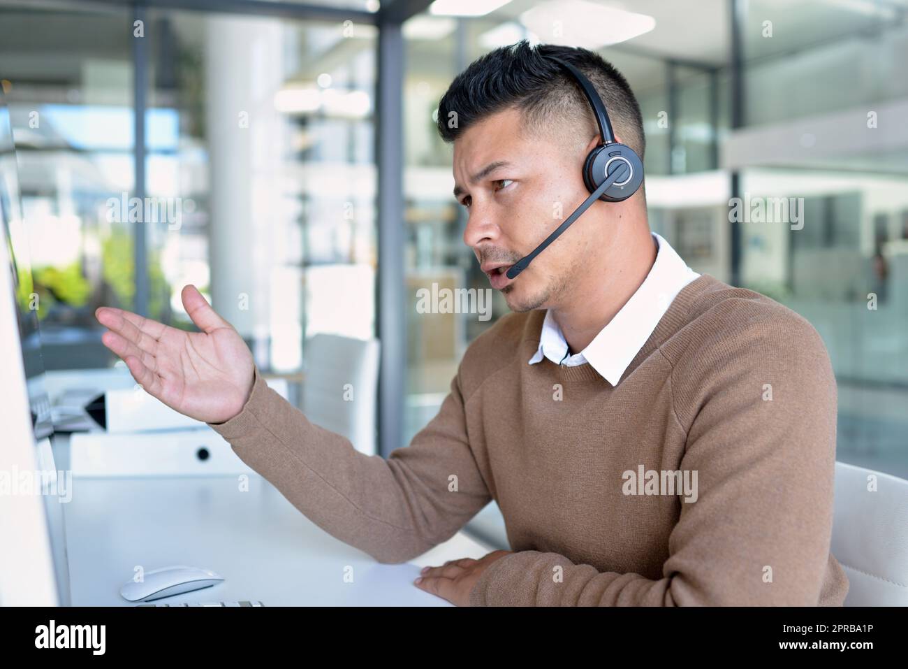 Let me run through the options for you... a young call centre agent working in an office. Stock Photo