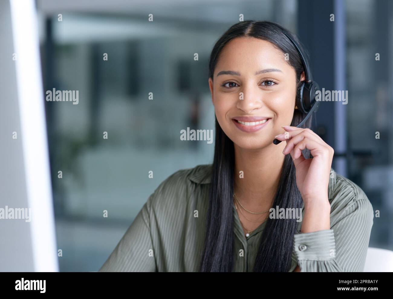 Its about responding directly to the needs of customers. Portrait of a young call centre agent working in an office. Stock Photo