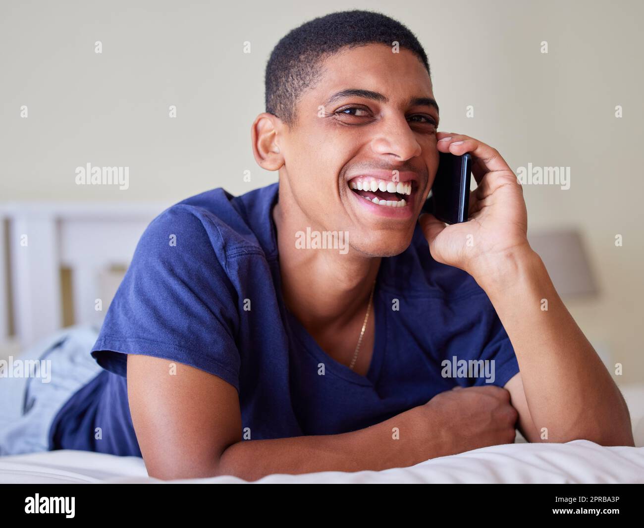 Enjoying my down time. a young man using his phone at home. Stock Photo