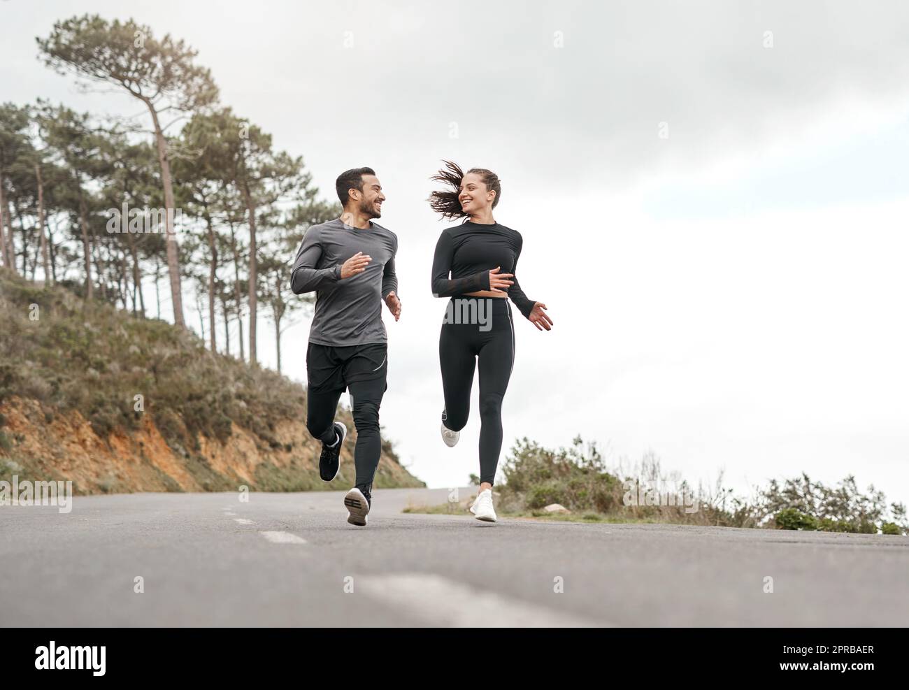 Were each others source of motivation. Full length shot of two young athletes bonding together during a run outdoors. Stock Photo