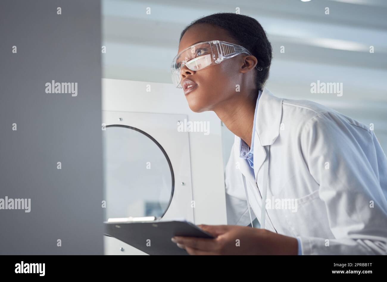 Building knowledge about the world through careful observations. a young scientist working in a lab. Stock Photo