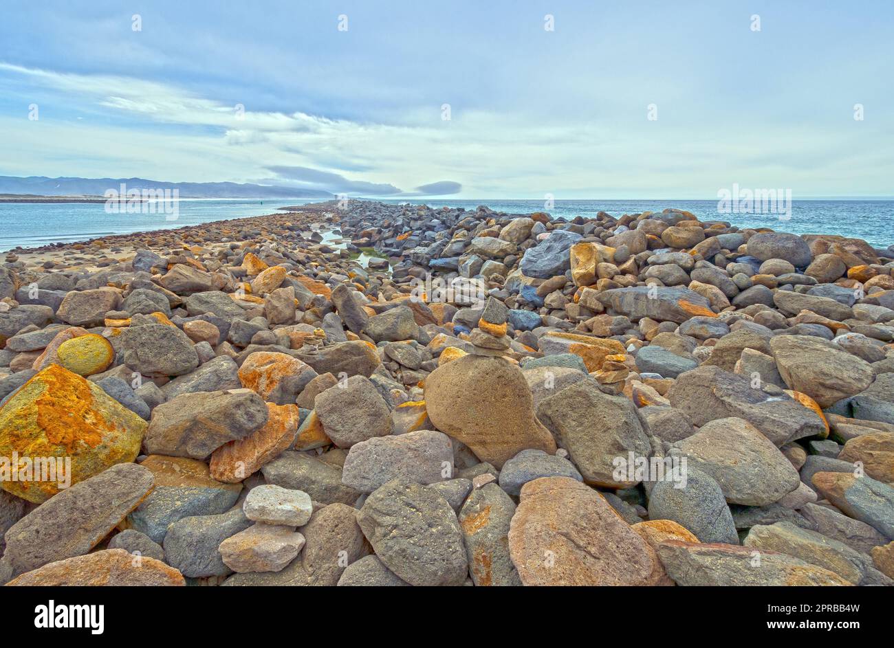 Colorful Boulders of a Breakwater Stock Photo