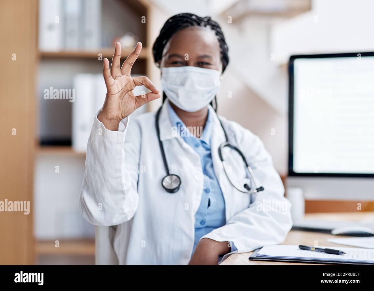 Practising professionalism that leads to perfectionism. Portrait of a young doctor making an okay sign. Stock Photo