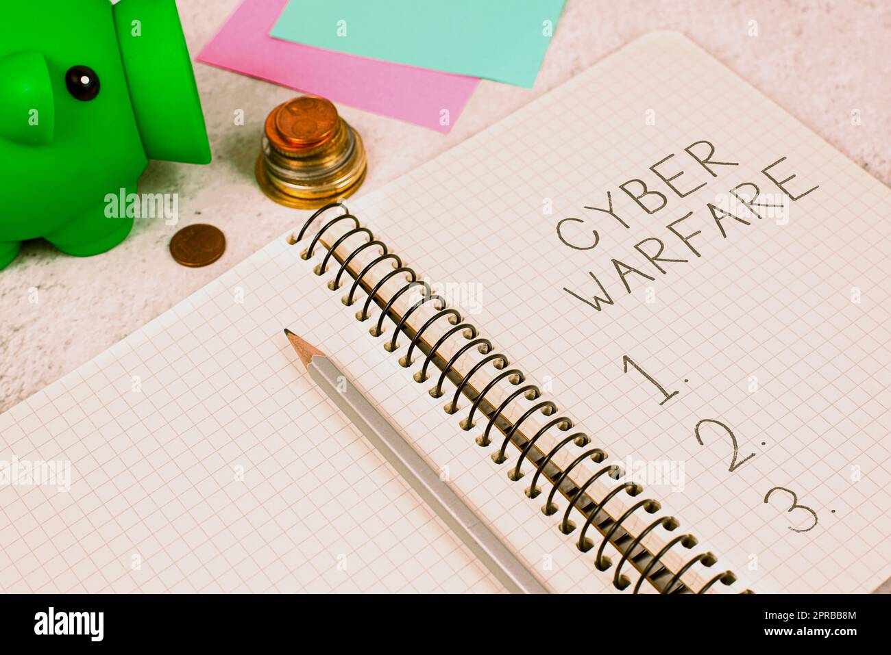 Conceptual caption Cyber Warfare. Business overview Virtual War Hackers System Attacks Digital Thief Stalker Important Message On Notebook On Desk With Money, Pen, Notes And Pig Box. Stock Photo