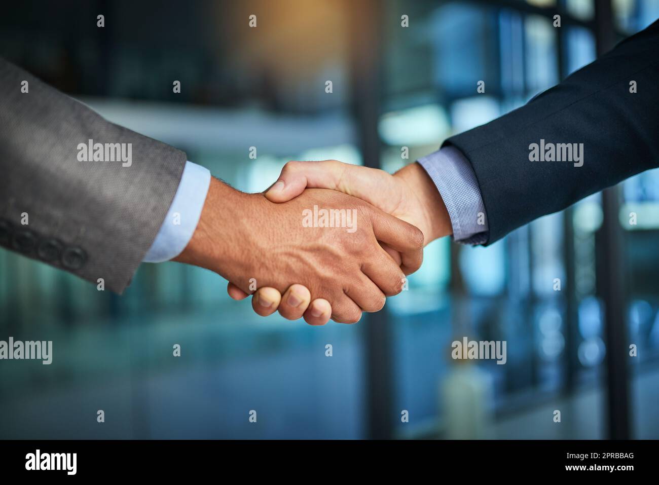 A handshake showing teamwork, collaboration and togetherness by business colleagues after a meeting in the office. A successful agreement has been reached by male coworkers in a business deal Stock Photo