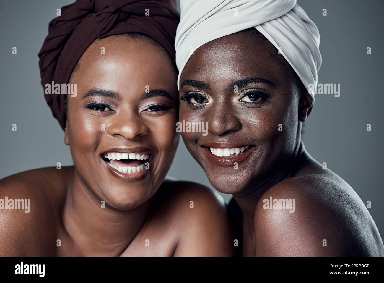 My sister is my best friend. Studio portrait of two beautiful young women posing against a grey background. Stock Photo