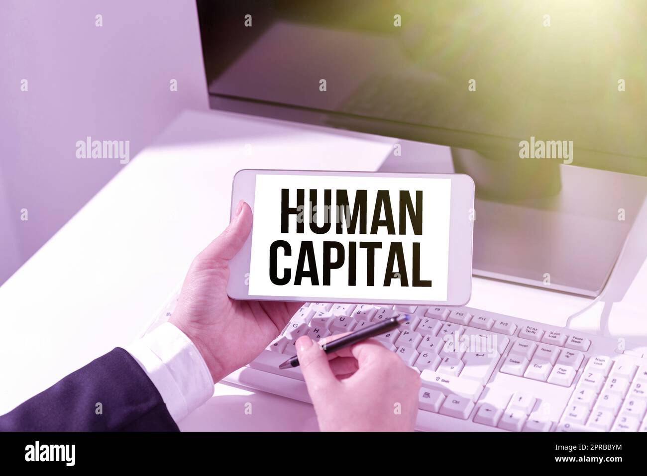 Sign displaying Human Capital. Business showcase Intangible Collective Resources Competence Capital Education Businesswoman Holding Mobile Phone With Important Messages Sitting On Desk. Stock Photo