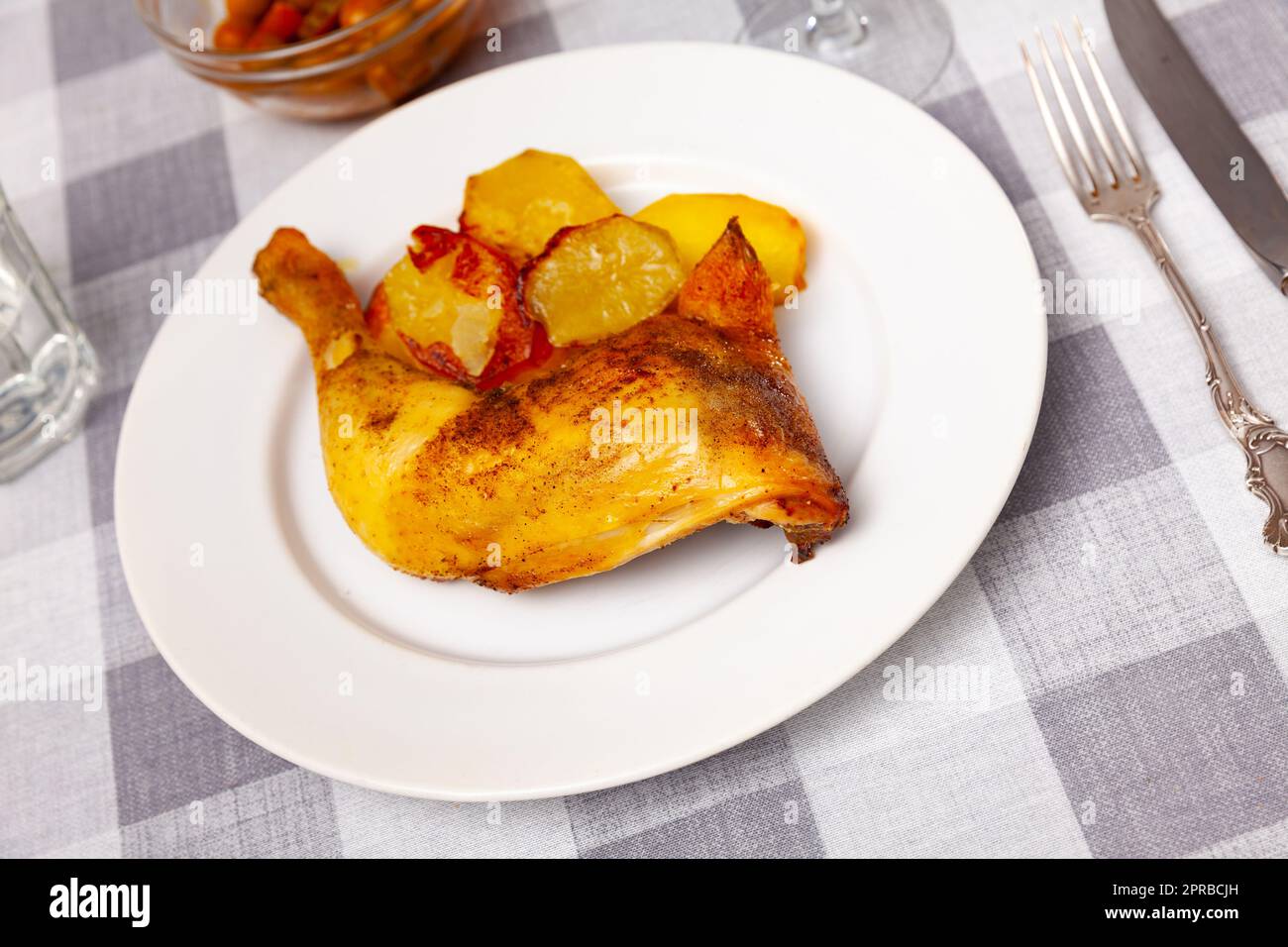 Roasted chicken quarter with crispy baked potatoes Stock Photo Alamy